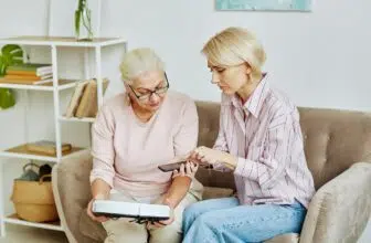 Woman Helping Mother With Smart Home