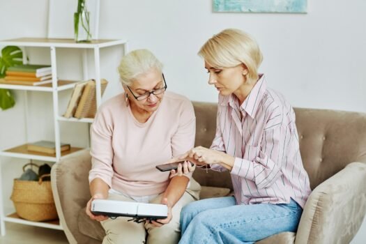 Woman Helping Mother With Smart Home