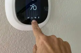 A homeowner and woman adjusts the settings and temperature on her ecobee smart thermostat
