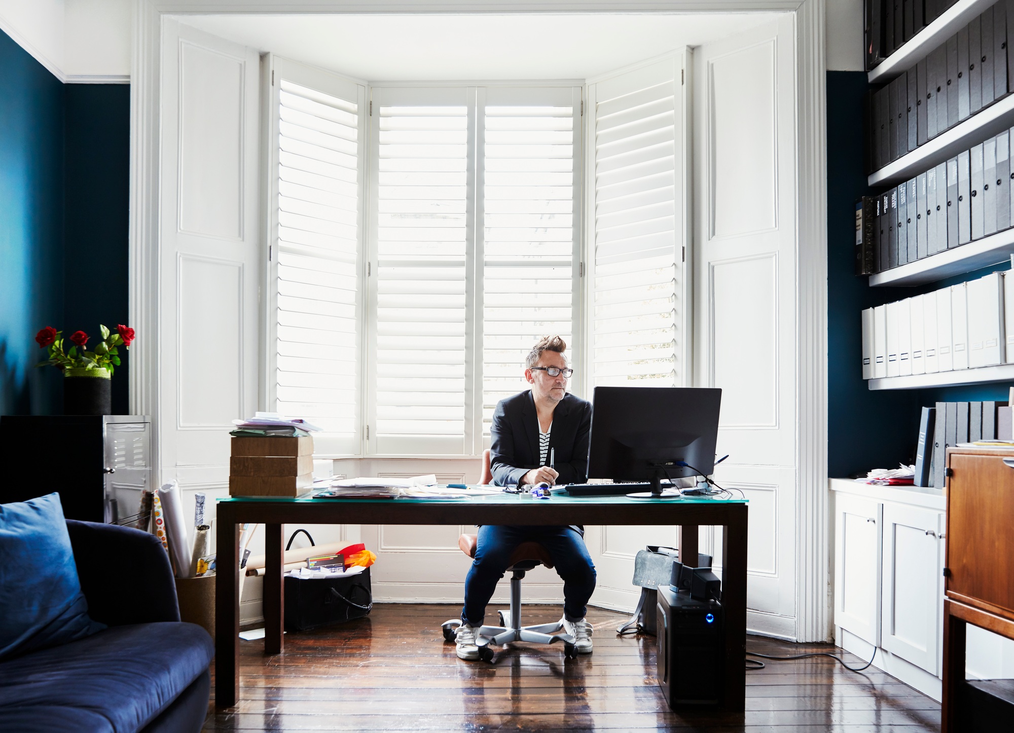 A man sitting at a desk in a home office.