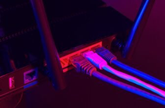 Cables Plugged In A Wi-Fi Router On Dark Background